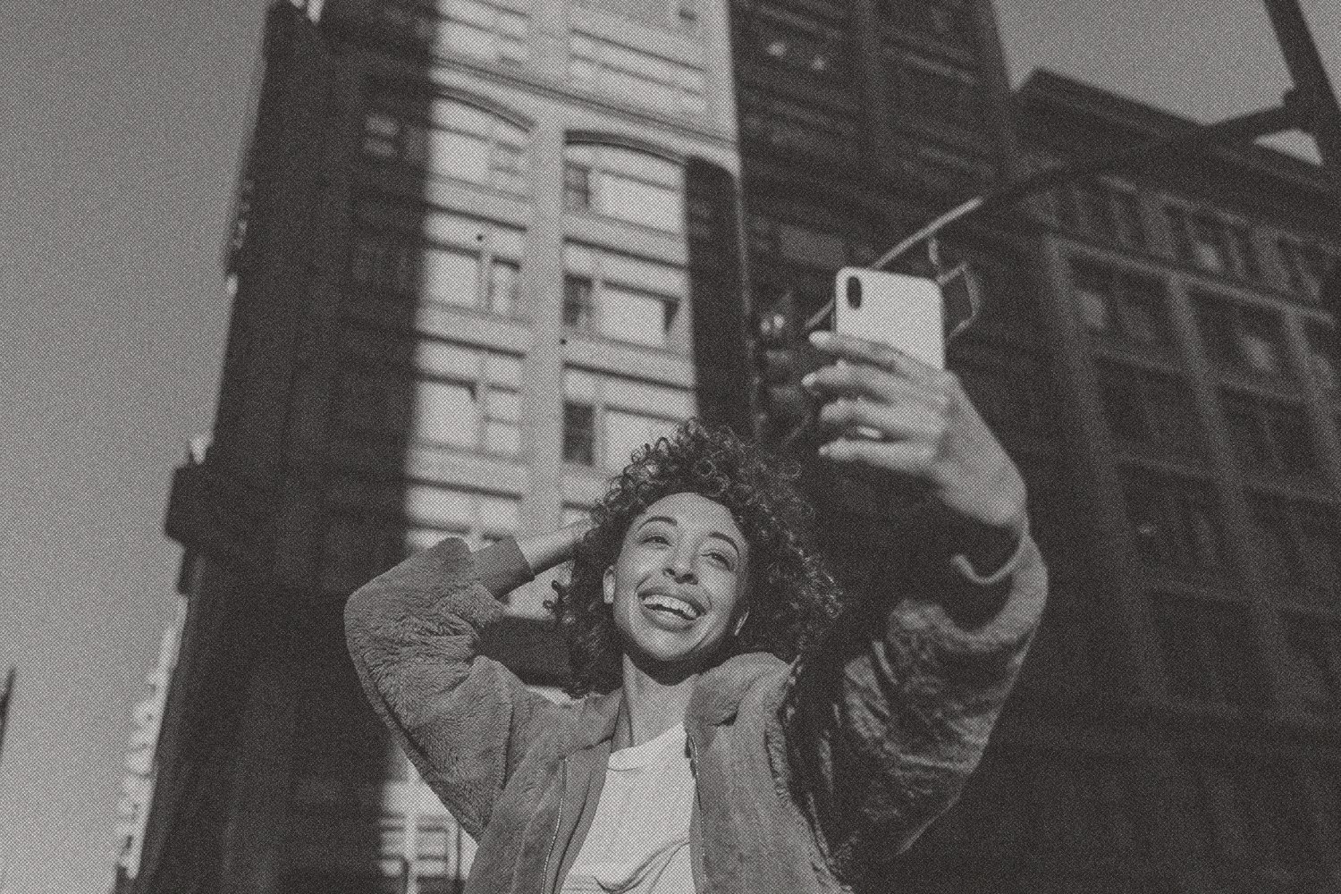 Person engaging with mobile technology in the city